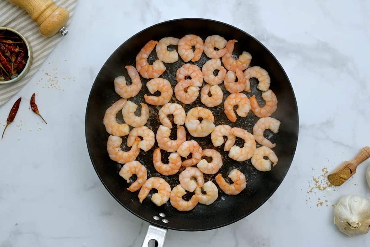 Small shrimp sauteed in skillet with sesame oil.