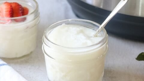Jar of homemade Instant Pot yogurt next to Instant pot.