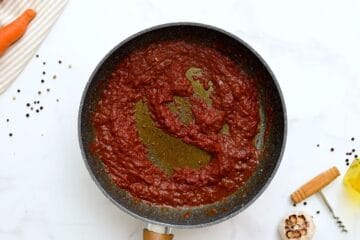 Red wine, onions, and tomato paste in skillet after simmering for a bit for beef stew.
