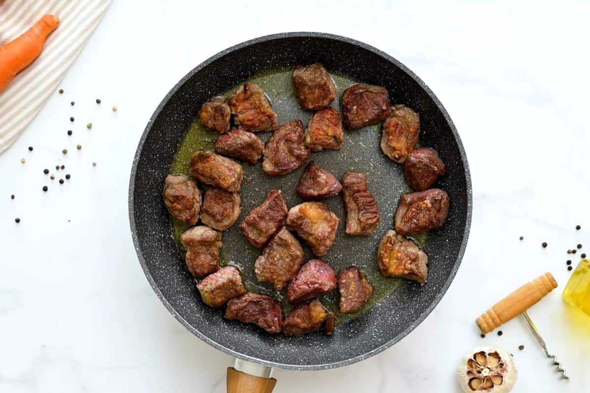 Beef Stew Recipe Browned chunks of floured chuck roast in skillet for base of beef stew.