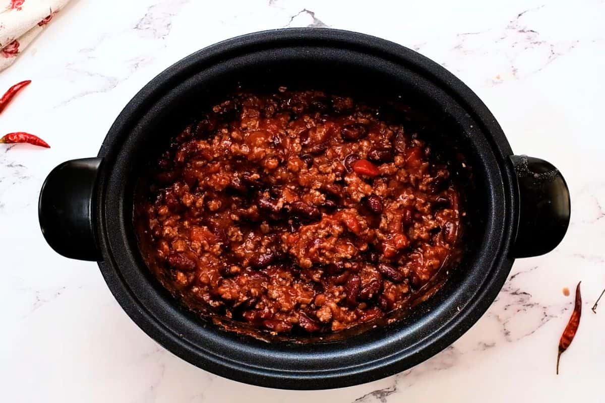 Slow Cooker Chili Recipe Ground beef, kidney beans, and tomatoes combined in slow cooker for chili base.