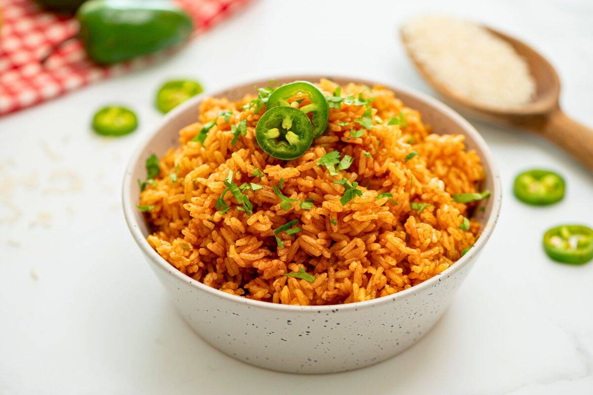 Tex Mex Recipes Perfectly cooked and seasoned Instant Pot Spanish rice fluffed and dished out in serving bowl.