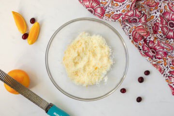 Orange zest and sugar combined together in large mixing bowl.