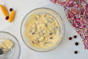 Batter for cranberry orange quick bread in mixing bowl after dry and wet ingredients are gently folded together.