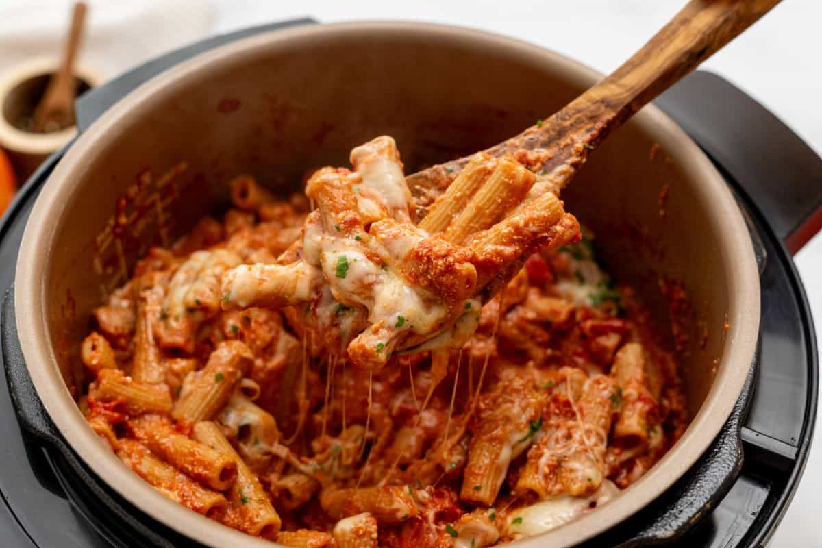 Recipes for Instant Pot Spoon scooping out perfectly cooked ziti with ricotta and tomato sauce from Instant Pot.