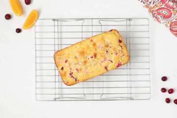 Cranberry Orange Loaf on wire cooling rack after being baked and removed from pan.