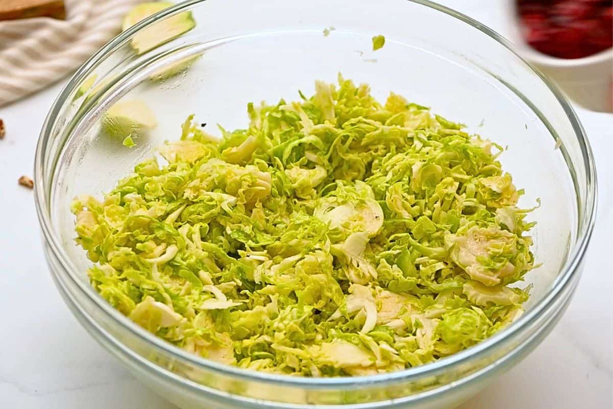 Shaved Brussels Sprouts Salad with Parmesan Shaved brussels sprouts tossed with honey lemon dressing.
