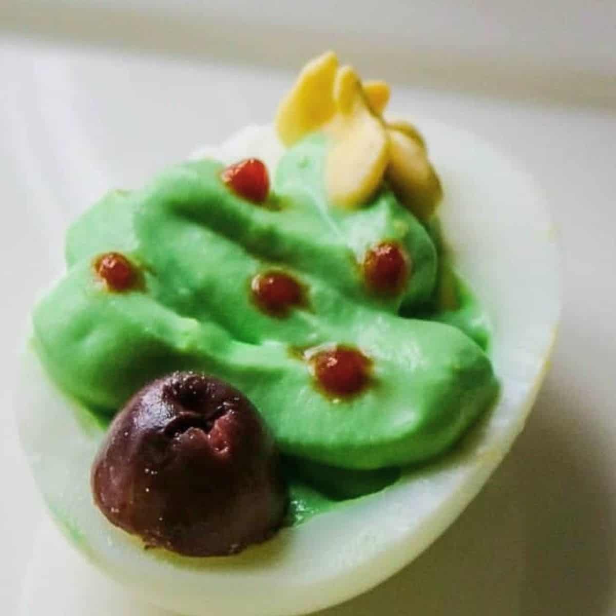 Christmas Appetizers Deviled egg with green filling made to look like Christmas tree.