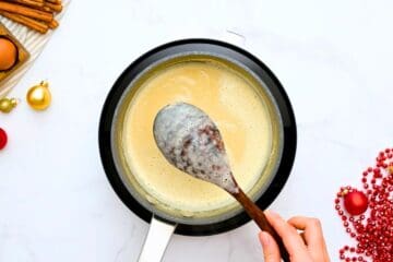 Wooden spoon coated with thick non dairy homemade eggnog.