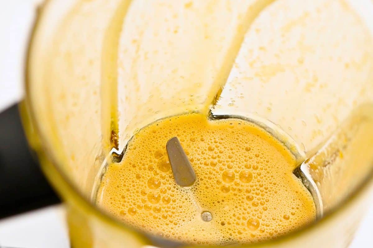 How to Make Homemade Eggnog Blender with egg yolks and maple syrup blended together until smooth.