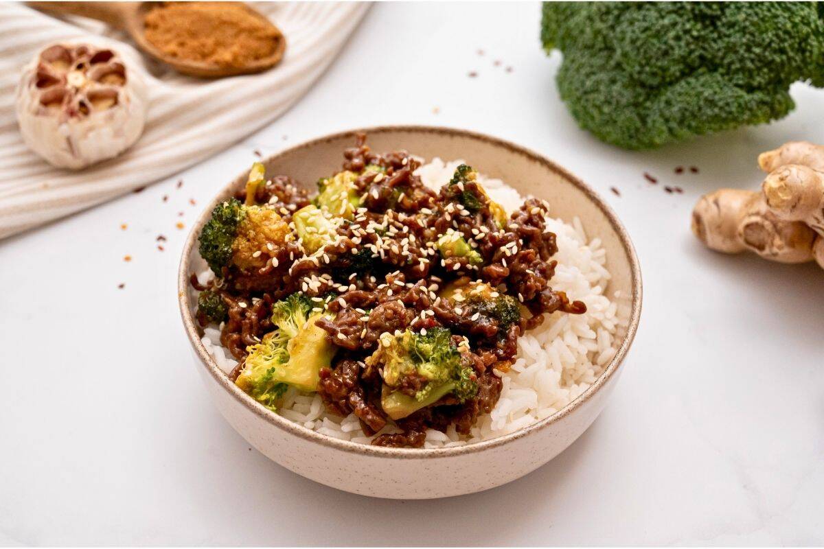 Beef and broccoli recipe Ground beef with crisp tender broccoli tossed with sweet and savory sauce served over white rice topped with sesame seeds.
