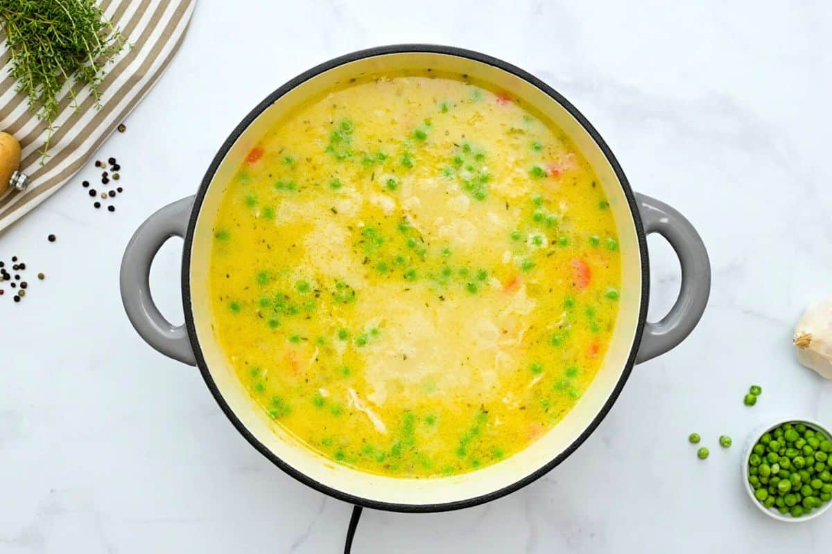 Recipe Chicken and dumpling soup Broth simmered with chicken stock, shredded chicken, peas, carrots, and potatoes to form creamy chicken and dumpling soup.