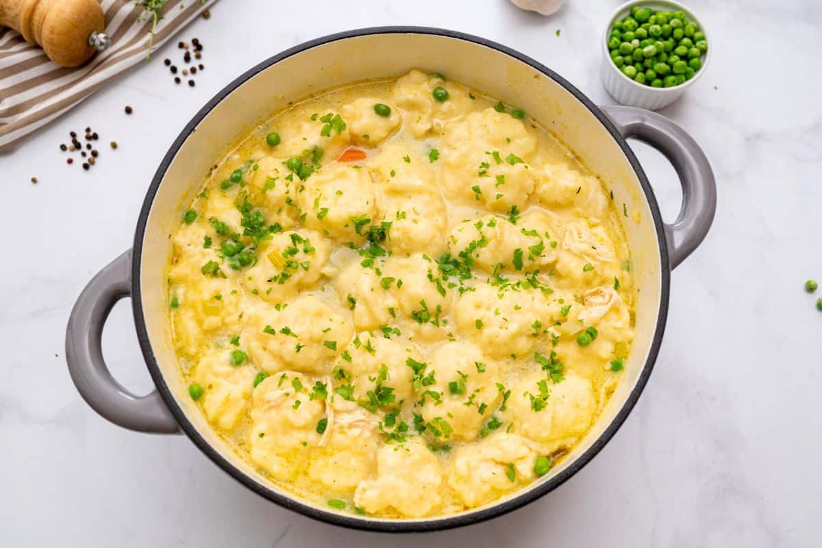 Recipe Chicken and Dumpling Soup Recipe Pot of homemade chicken pot pie soup with cream, shredded chicken, cooked carrots, potatoes, peas and homemade dumplings.