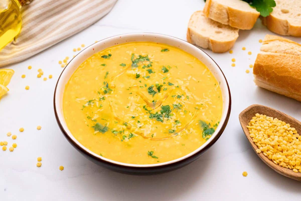 Bowl of Italian Pastina soup served with a drizzle of olive oil, fresh minced parsley, and parmesan cheese.