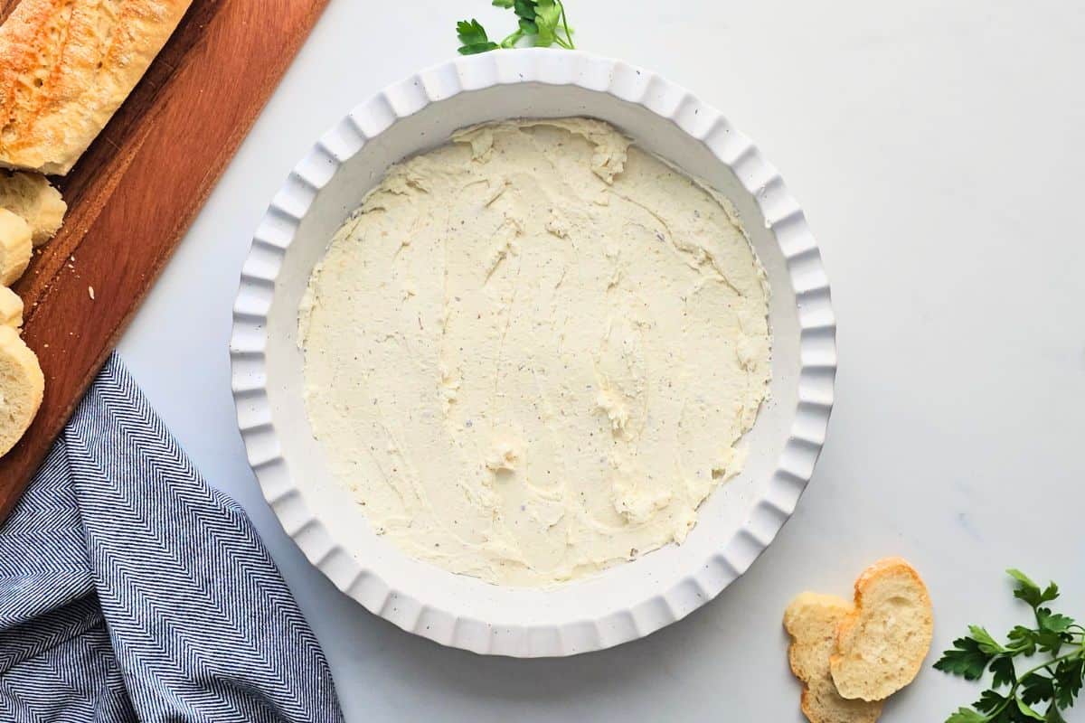 Cottage Cheese Pizza Dip Cream cheese and cottage cheese based spread out in shallow layer in pie plate.