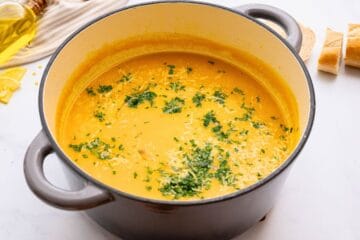 Pot of Italian Pastina soup served with a drizzle of olive oil, fresh minced parsley, and parmesan cheese.