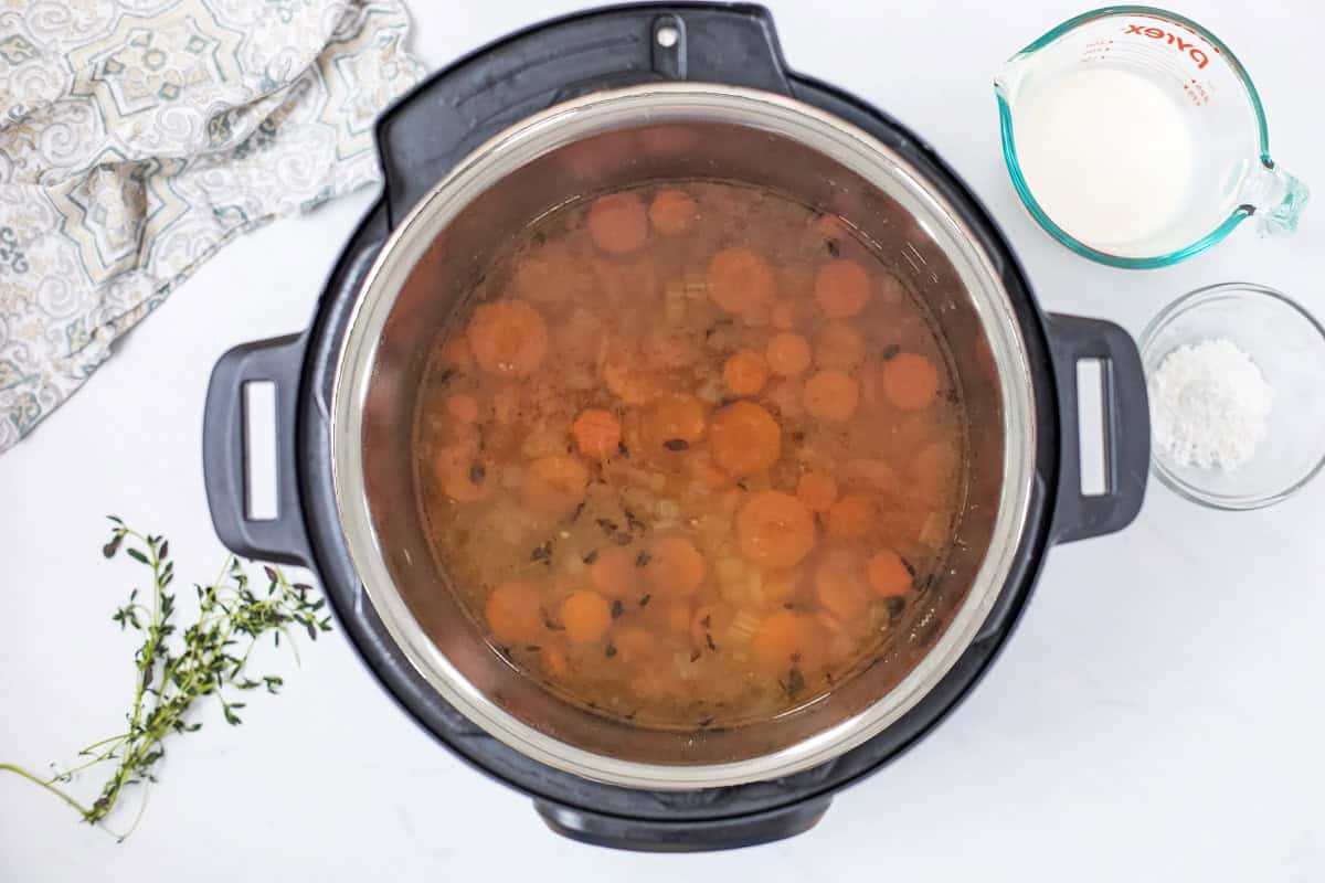 Instant Pot Creamy Wild Rice Soup Wild rice soup in Instant Pot after being pressure cooked and pressure released before adding cream.