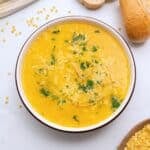 Bowl of Italian Pastina soup served with a drizzle of olive oil, fresh minced parsley, and parmesan cheese.