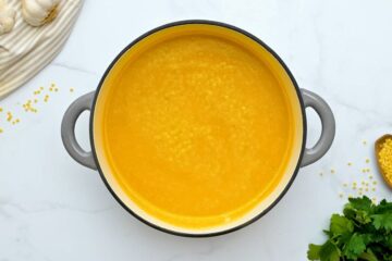 Pot of soup made with pureed vegetables, chicken stock, and pastina pasta.