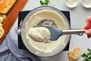 Spatula showing blended base made in food processor with seasonings, cottage cheese, and cream cheese.