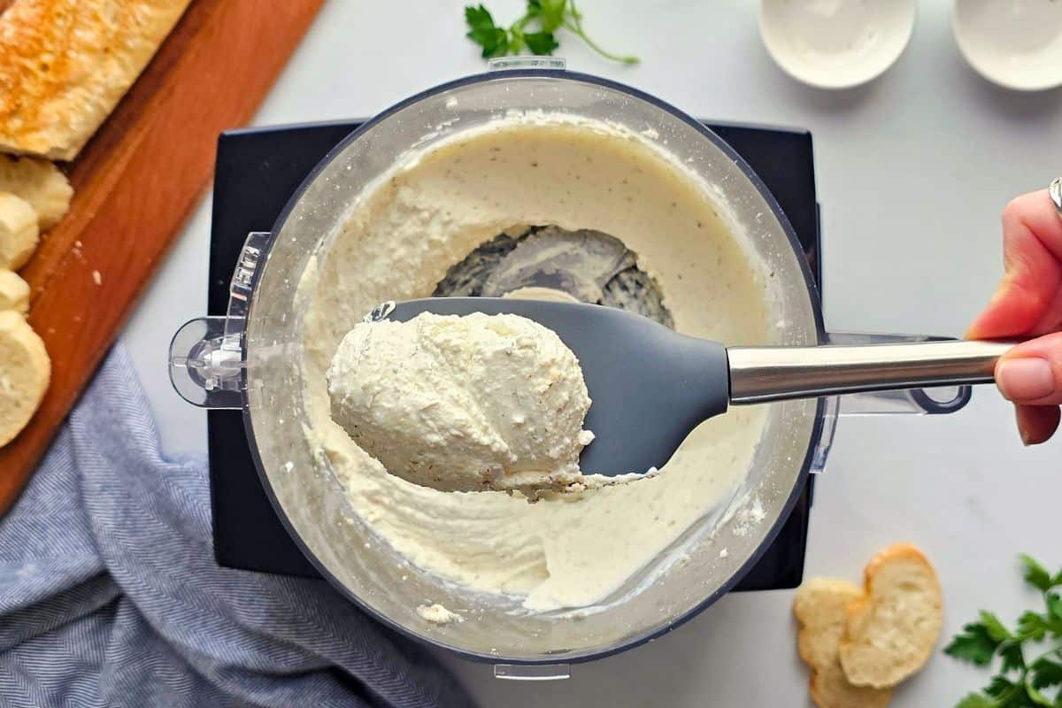 Pizza Dip with Cream Cheese Spatula showing blended base made in food processor with seasonings, cottage cheese, and cream cheese.