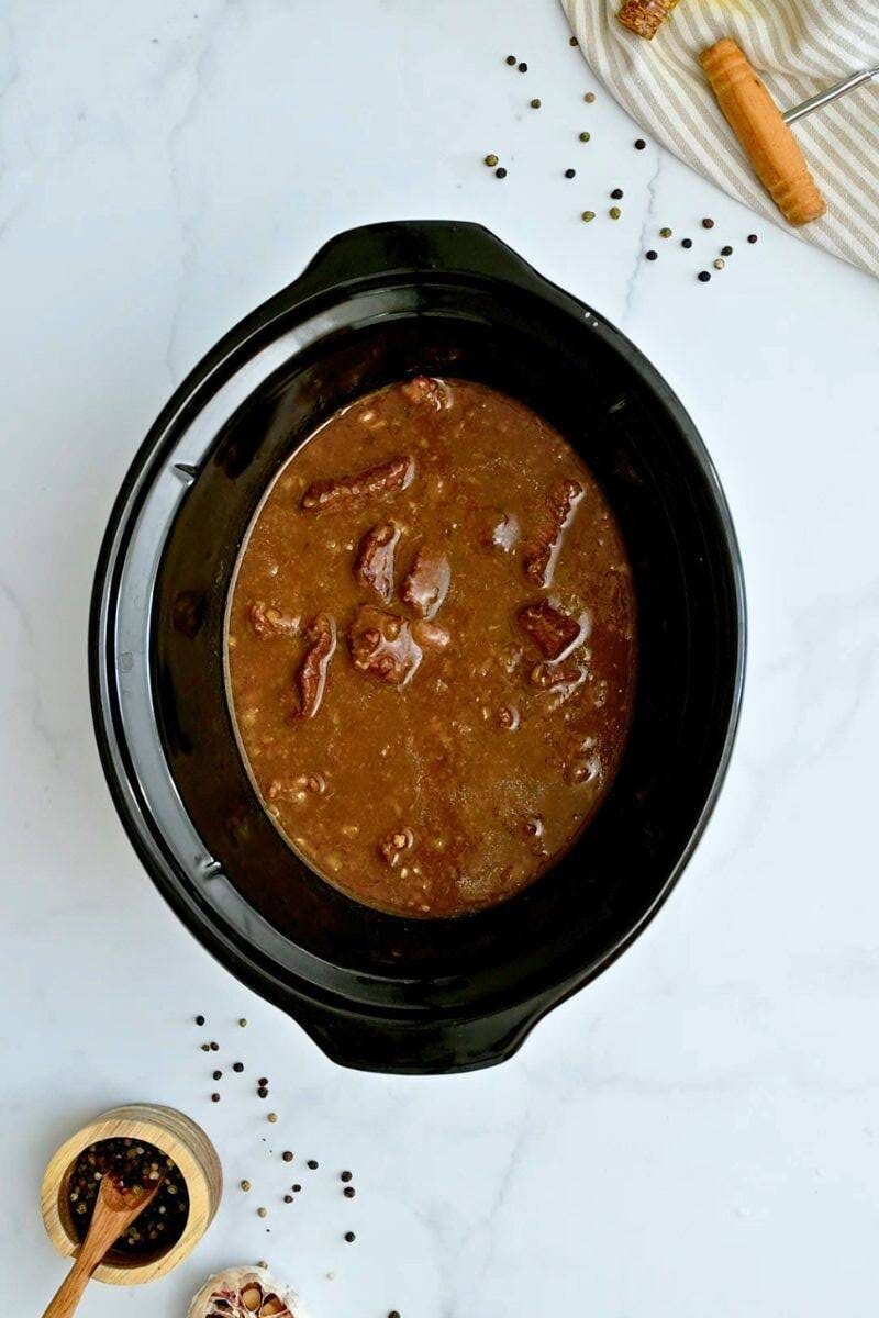Slow Cooker Beef Tips with Gravy Beef tips in slow cooker after being slow cooked for 8 hours.