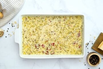 Dried orzo, cream, broth, sun-dried tomatoes, and seasonings combined in baking dish.