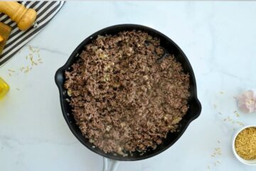 Ground beef, onion, and garlic sauteed together in large deep skillet.