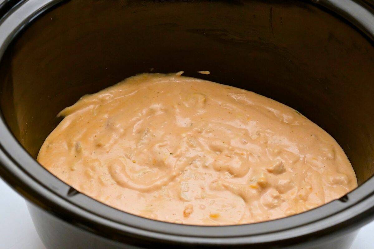Crockpot Buffalo Chicken Wing Dip Cream cheese, ranch dressing, shredded cheese, garlic powder, hot wing sauce, and diced chicken cooked until warm and creamy inside the slow cooker.