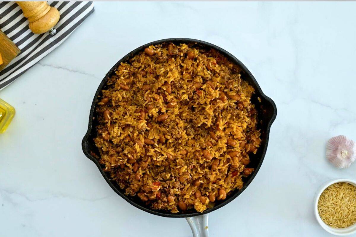Taco and Rice Bake Baked rice with taco meat and pinto beans fluffed in skillet.