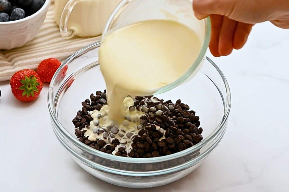 Chocolate Bundt Cake with Ganache Frosting Warm cream being poured over chocolate chips to make ganache topping.