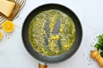 Saute pan with melted butter, olive oil, and minced garlic and crushed red pepper flakes for base of lemon spaghetti sauce.
