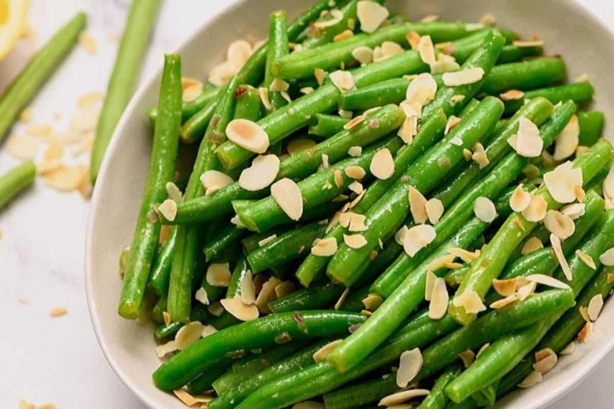 Favorite Easter Dinner Recipes Green Beans Almondine in white serving platter.