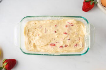 Batter for fresh strawberry bread in glass baking dish.