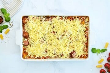 Baked rigatoni after baking until tender topped with cheese in large casserole dish.