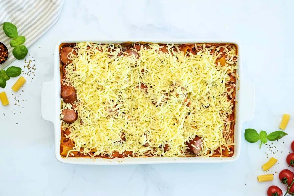 Cheesy Baked Rigatoni Baked rigatoni after baking until tender topped with cheese in large casserole dish.