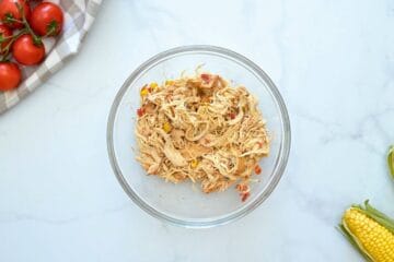 Shredded CHicken in bowl after being slow cooked in crockpot for chicken tortilla soup.