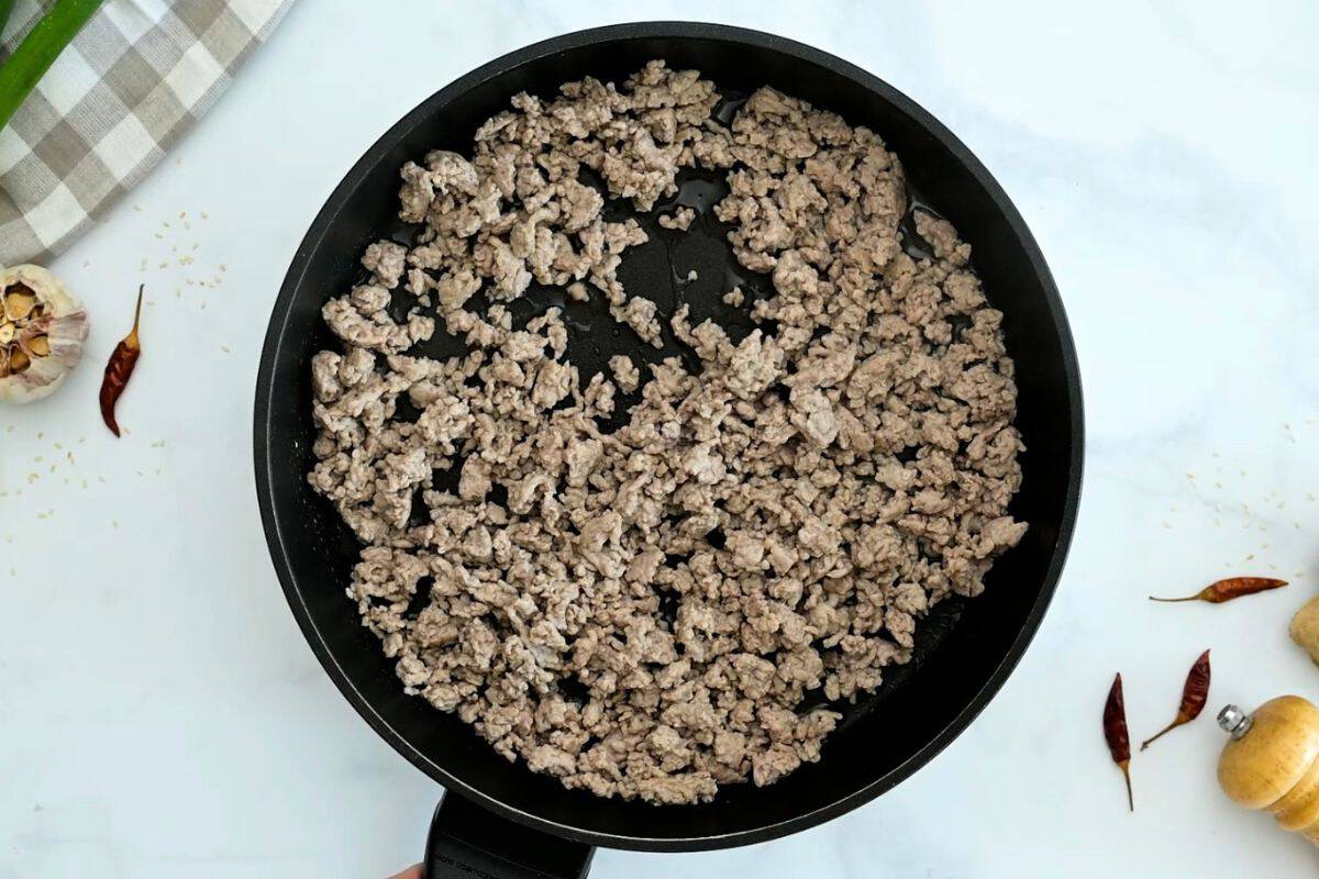 Low Carb Egg Roll in a bowl Browned ground turkey in skillet for base of egg roll bowl.