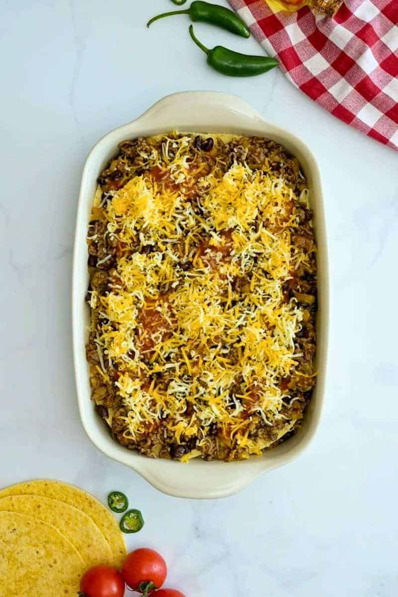 Ground Beef Enchilada Bake Layers of seasoned beef enchilada filling, corn tortillas, enchilada sauce, and cheese layered in 9x13-inch baking dish.
