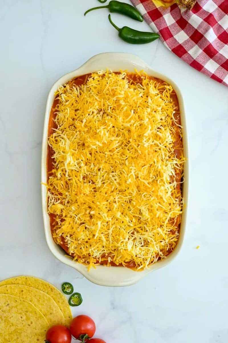 Ground Beef Enchilada Casserole Layers of seasoned beef enchilada filling, corn tortillas, enchilada sauce, and cheese layered in 9x13-inch baking dish.