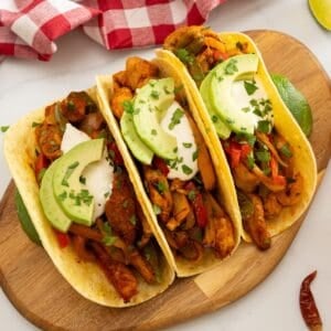 Roasted chicken, peppers and onions served in tortillas with sour cream and avocado and minced cilantro.