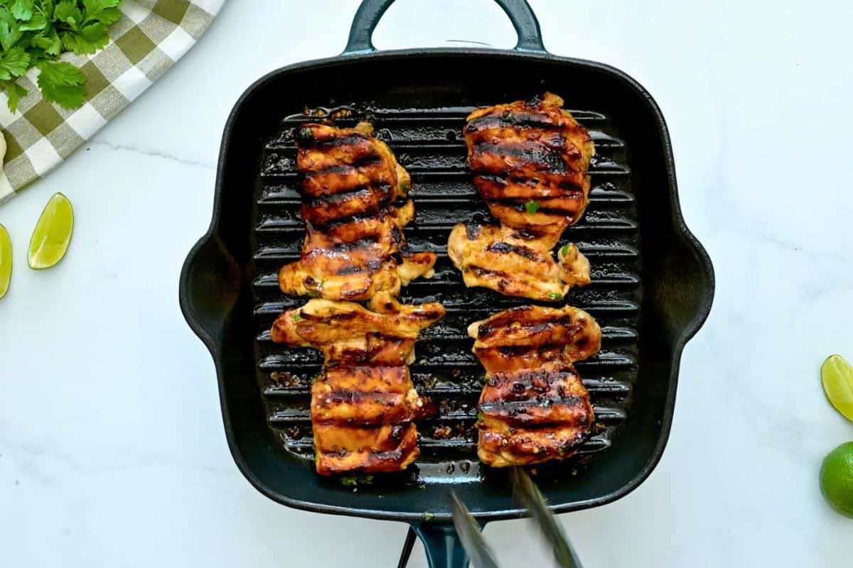 Easy Cilantro Lime Chicken Marinade Grilled chicken thighs marinated in cilantro lime marinade on grill pan.