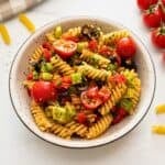 Pasta salad made with rotini noodles, Italian dressing, and summer veggies in white bowl.