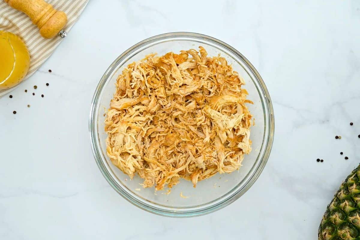 Crockpot Shredded BBQ Chicken Breasts Slow cooked chicken breasts shredded in large mixing bowl.