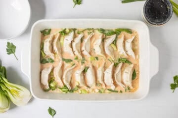 Frozen potstickers placed in single layer on top of spiced, soy coconut broth and sliced bok choy.