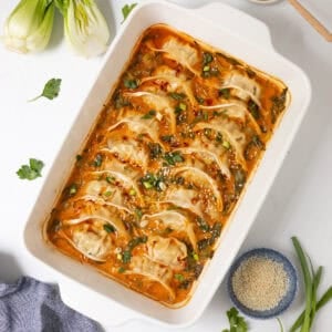 Potstickers baked in curry-soy coconut broth with sliced bok choy topped with chili crisp, green onions, and sesame seeds.