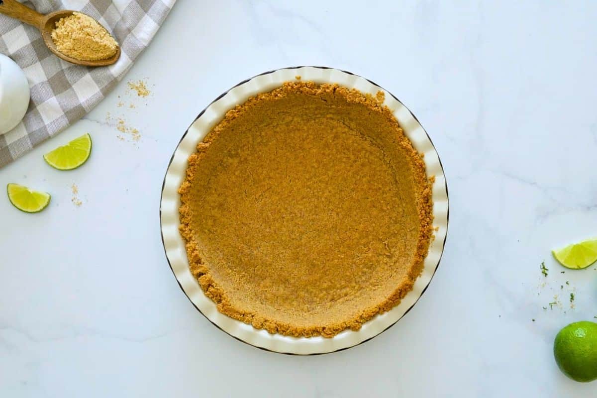No Bake Key Lime Pie with Graham Cracker Crust Baked homemade graham cracker crust in pie plate.