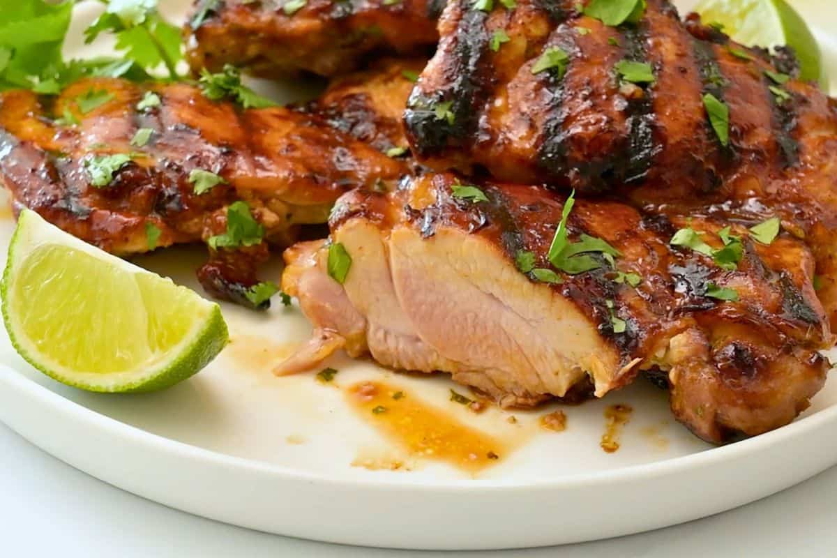 Easy Chicken Marinade with Lime Marinated honey cilantro lime chicken thigh cut open to show how juicy.