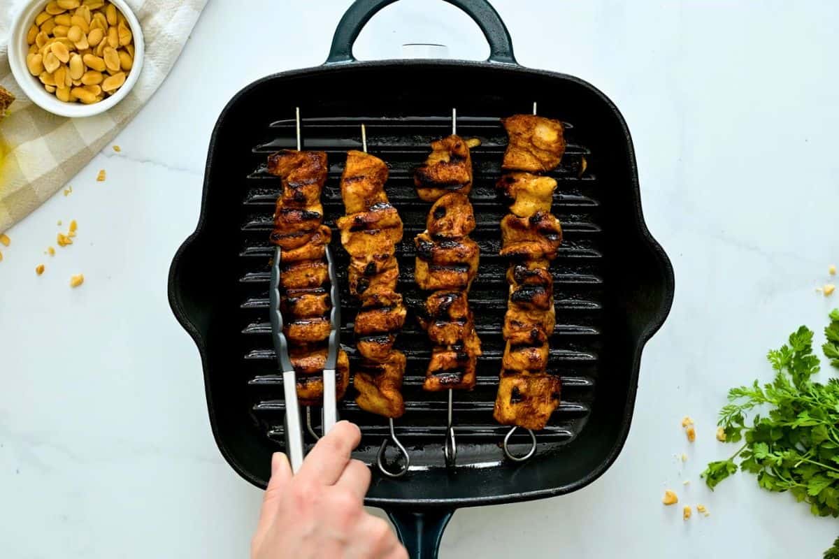 Chicken Kabobs Grilled Chicken Kabobs on metal skewers on grill plate.