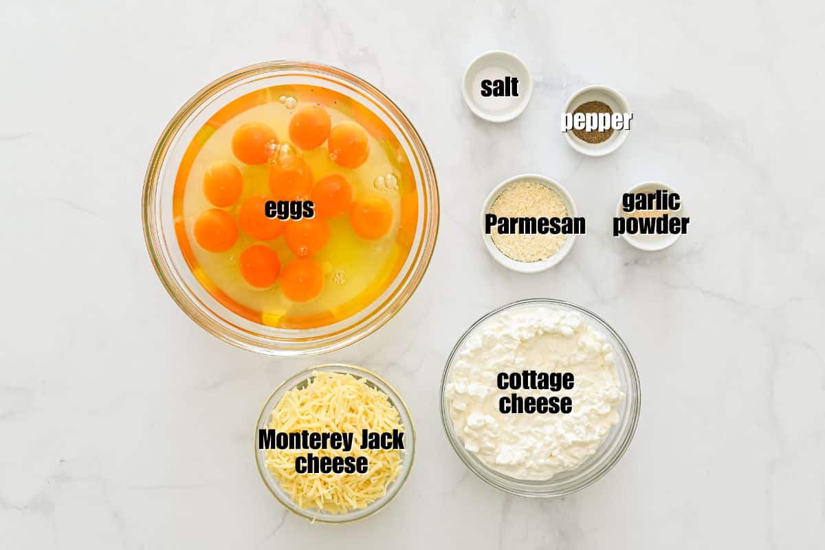 Egg Bake with Cottage Cheese Eggs, cottage cheese, Parmesan, salt, pepper, and garlic powder laid out in bowls on counter.